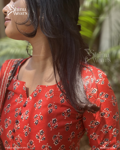 Woman wearing a red patterned outfit with 'Shinu Wears' branding.