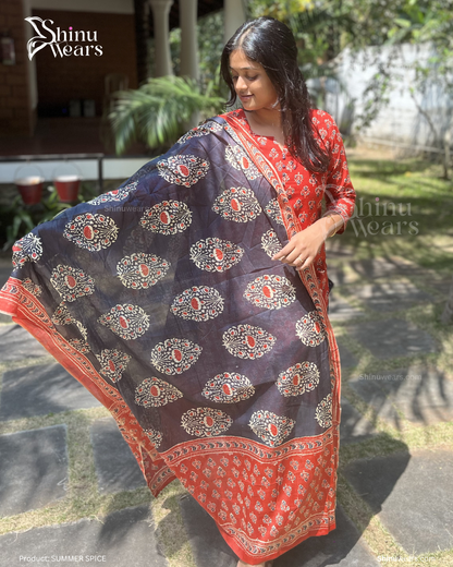 Woman holding a navy blue and red patterned scarf with 'Shinu Wears' branding.