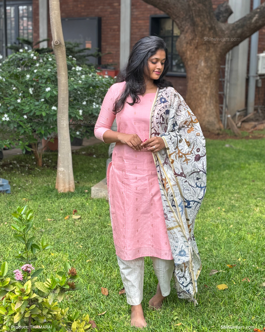 Model showcasing Thamarai raw silk set with Kalamkari dupatta in garden backdrop. Page maintained by Creations by Nash.